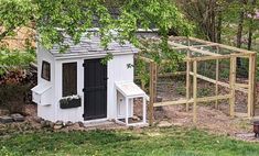 a small chicken coop in the middle of a yard