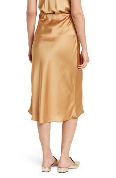 Elevate your wardrobe with this pull-on bias satin midi skirt for elegant, feminine style. 31" length (size S) Elasticized waist Pull-on style Satin construction 97% polyester, 3% spandex Machine wash cold, line dry Made in USA Model’s stats for sizing: 5’10” height, 34” bust, 27” waist, 35” hips. Model is wearing size S. Satin Midi-length Bottoms For Work, Satin Midi Bottoms For Workwear, Satin Gold Skirt, Sleek Satin Bottoms Midi Length, Sleek Satin Midi Bottoms, Elegant Knee-length Satin Bottoms, Chic Satin Knee-length Bottoms, Chic Knee-length Satin Bottoms, Relaxed Fit Satin Midi Pencil Skirt