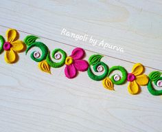 an embroidered ribbon with flowers and leaves is shown on a wooden surface, along with the words ranggol by apurva