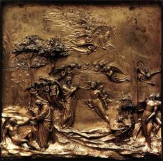 a gold plate with an image of the birth of jesus and other figures on it