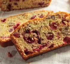 sliced loaf of fruit bread sitting on top of a table