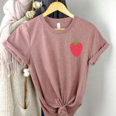 Strawberry Shirt UNISEX T-Shirt Bella+Canvas 3001 .: 52% Airlume combed and ring-spun cotton, 48% polyester .: Light fabric (4.2 oz/yd² (142 g/m .: Runs true to size Shipping policies ❤️ TURN-AROUND TIME: Our current processing time is 3-7 days (not including shipping time). ❤️ SHIPPING: Our packages are shipped with USPS First Class Shipping times (not including processing times): First Class: 2-10 business days ❤️ Returns & exchanges I don't accept returns, exchanges, or cancellations All Fruit Outfits, Strawberry Clothes, Strawberry Clothing, Cottage Core Clothes, Core Clothes, Dental Assistant Shirts, Strawberry Aesthetic, Pink Closet, Godmother Shirts