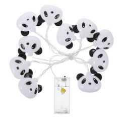 a bunch of panda bears that are on a string with some lights attached to it