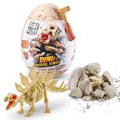 the dinosaur egg is next to some rocks and a toy t - rexe with it's head sticking out