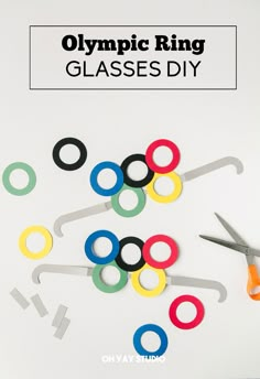 olympic ring glasses - diy with scissors and paper clips on top, in front of the olympics logo