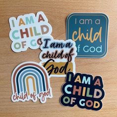 several stickers on a wooden surface that say i am a child of god, i am a child of god and i am a child of god