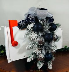 a decorated mailbox with silver and black ornaments