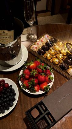 chocolates, strawberries and other fruit are on the table