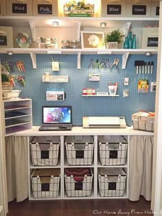 an organized craft room with shelves and bins