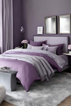 a bed with purple sheets and pillows in a bedroom next to two mirrors on the wall