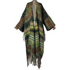 Upgrade your fall wardrobe with our Plaid Fringe Maxi Cardigan. Made with high-quality materials, this cardigan features a stylish plaid pattern and trendy fringe detailing. With its versatile maxi length, this cardigan is the perfect addition to any outfit. Stay warm and stylish with this must-have piece. - Color: Multicolor- Style: Maxi Cardigan with Fringe Tassel- Pattern Type: Plaid- Sleeve Length: Long sleeve- Material: Polyester- Closure Type: Open front- Details: Stylish tassel cardigan- Oversized Tassel Outerwear For Fall, One Size Fringe Cardigan For Fall, Oversized Fringe Cardigan For Fall, Long Fringed Outerwear For Winter, Long Winter Outerwear With Fringe, Long Fringe Outerwear For Winter, Long Fall Outerwear With Tassels, One Size Tassel Cardigan For Fall, Long Winter Outerwear With Tassels