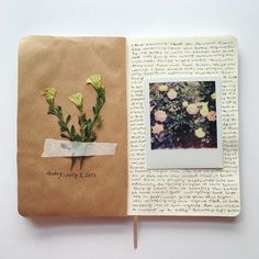 an open book with some flowers on it