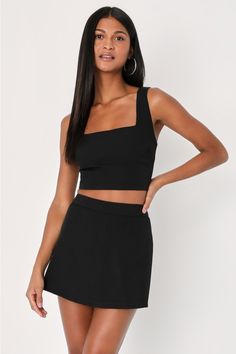 Let your confidence show all summer long in the Lulus Divinely Sunny Black Sleeveless Two-Piece Romper! Slightly stretchy, crepe woven fabric shapes this adorable two-piece romper that has a tank-style top with wide straps, flattering bust darts, and a cropped hem. Matching skort has a high, banded waist and a skirt-effect overlay panel at the front, atop a pair of fun-ready shorts. Exposed silver zipper at back of top. Hidden zipper/clasp at back of skort. Fit: This garment fits true to size. L Sleeveless Two-piece Set Tops For Summer, Sleeveless Two-piece Summer Tops, Summer Sleeveless Two-piece Crop Top, Summer Sleeveless Two-piece Top, Summer Party Tank Top In Elastane, Two-piece Summer Tops For Night Out, Chic Sleeveless Solid Crop Top, Trendy Sleeveless Elastane Crop Top, Two-piece Sleeveless Stretch Top