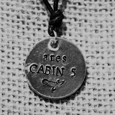 a necklace that says area 3 cabin s on it's front and back side