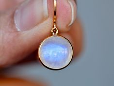 Lovely genuine rainbow moonstone is set in 18k gold. Lightweight and gorgeous, these are a great gift for anyone on your list. Perfect for everyday wear or for those who like to make a dainty minimalist statement. The moonstone drops are super sparkly and a lovely opaque color with rainbow tones. Size : 10mm Metal : 18kt Gold Gemstones : 8 ct Rainbow Moonstone More about Moonstone ... Rainbow Moonstone acts as a prism, diffusing energy throughout the aura. It is said to provide psychic protectio Moonstone Round Yellow Gold Earrings, Round Moonstone Yellow Gold Earrings, Gold Moonstone Drop Crystal Earrings, Yellow Gold Round Moonstone Earrings, Moonstone Yellow Gold Round Earrings, Yellow Gold Moonstone Dangle Earrings, Rainbow Moonstone Earrings, Rainbow Moonstone Pendant, Blue Moonstone