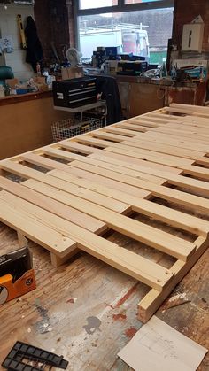 a wooden bed frame sitting on top of a hard wood floor