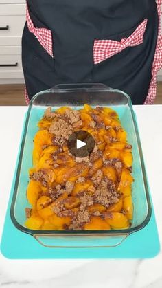 a casserole dish with meat and vegetables in it sitting on a blue tray