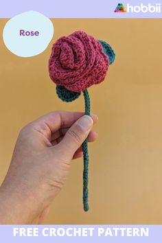 a hand holding a crocheted flower with the text rose above it that reads, free crochet pattern