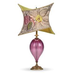 a lamp with a pink glass shade on it