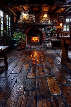 a room with wood floors and stone fireplace