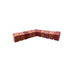 several pieces of red and pink clay sitting on top of each other in the shape of rectangles