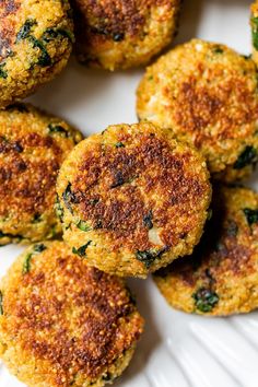 several small crab cakes on a white plate