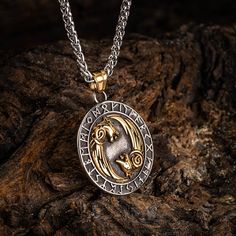 There are times when the moon is full and we want to feel its power. Other times, we want to represent our inner wolf. This Dual Colored Stainless Steel Circular Twin Wolf Necklace does both, with a special ring of runes surrounding two wolves engraved in gorgeous detail on this high quality stainless steel pendant. Also features a Helm of Awe on the reverse with the inscription: "The brave shall live forever in the halls of Valhalla" Pendant is approx. 1.5" across (4cm) and comes complete with Gold Viking Style Jewelry, Viking Style Wolf Design Jewelry Gift, Halls Of Valhalla, Helm Of Awe, Two Wolves, Norse Jewelry, Wolf Necklace, Viking Necklace, Special Ring