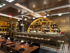 an empty restaurant with wooden tables and chairs