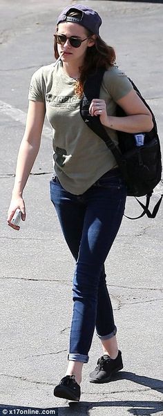 a woman walking down the street carrying a backpack