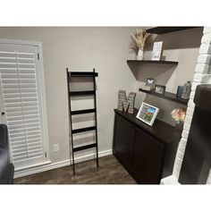 a living room with a fireplace and shelves