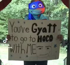 a person holding a sign that says you've got to go to hoco with me