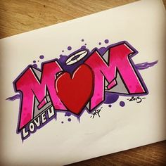 a piece of paper with the word mom painted on it and a heart in the middle