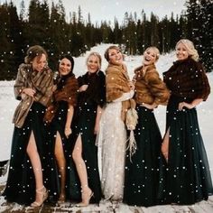 a group of women standing next to each other in the snow