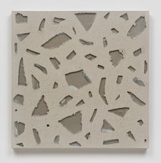 an abstract piece of art that looks like it has been made out of concrete and is on