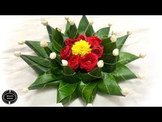 a bouquet of red and yellow flowers with green leaves