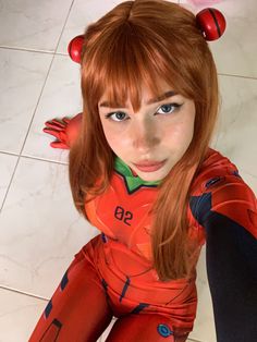 a woman with red hair and blue eyes wearing a costume