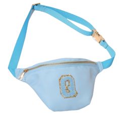 a blue fanny bag with the letter g on it's side and a gold buckle