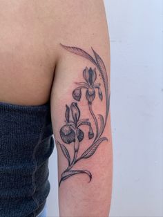 a woman's arm with a flower tattoo on the left side of her body