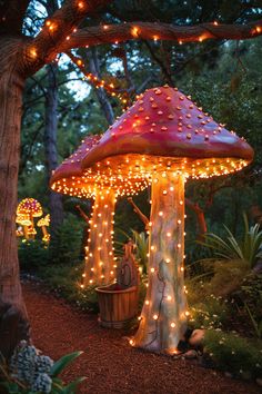 a lit up mushroom like structure in the middle of a forest with lights on it