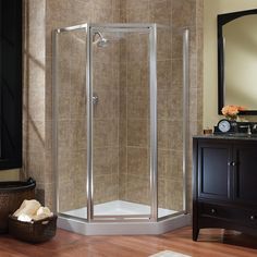 a bathroom with a walk in shower next to a sink and mirror on the wall