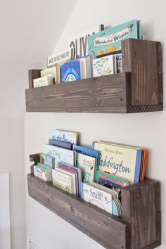 two wooden shelves holding books on the wall