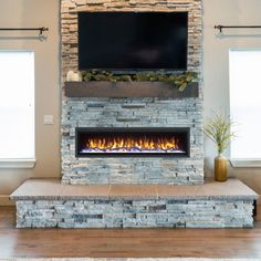 a stone fireplace with a flat screen tv above it