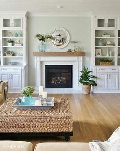 a living room filled with furniture and a fire place in the middle of a room