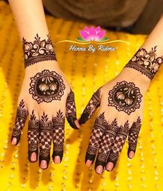 two hands with henna designs on them