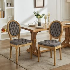 a dining room table with chairs and a rug