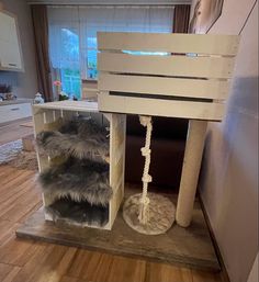 a cat house made out of pallet wood with fur on the bottom and sides