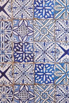 blue and white tiles with designs on them