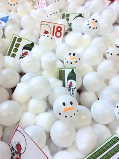 there are many white balloons with snowmen on them and numbers in the middle one