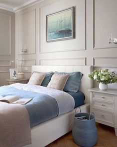 a bedroom with white walls and blue bedding