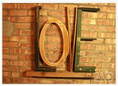 a wooden toilet sitting on top of a shelf next to a brick wall